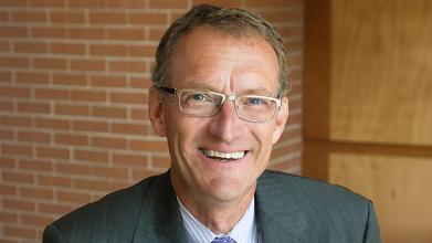 Photo of Mark Behrens with a brick wall background